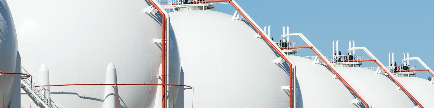 Getty Images 1143238367 - LPG gas storage sphere tanks with blue sky background
