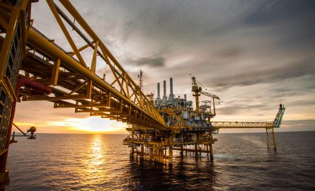 Getty Images 179565748 Oil and gas platform during sunrise or sunset